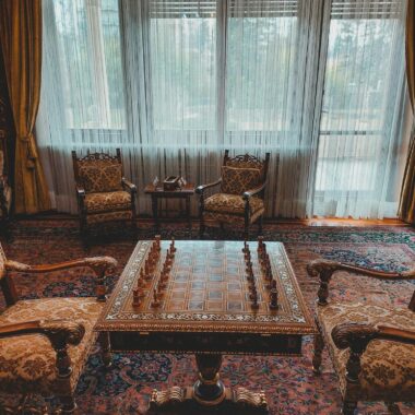 A sophisticated chess setup in a luxurious Parisian room with vintage decor.